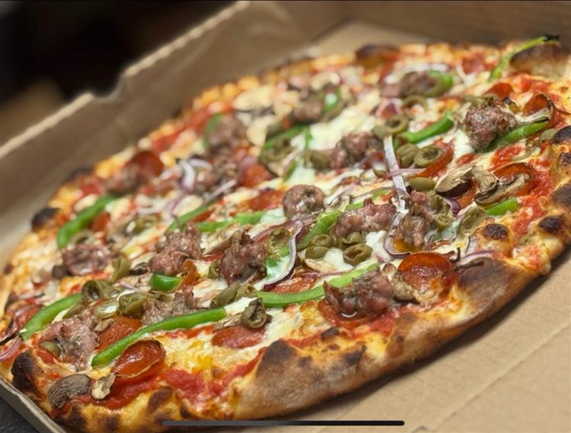 Dianna Rossa pizza with sausage, green peppers, olives, and onion